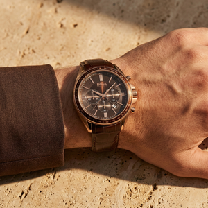 Close up of Hugo Boss Driver Runner 1513093 on wrist showing brown dial and rose gold case with 50m water resistance
