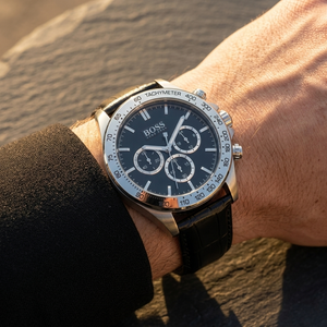 Close up of Hugo Boss Ikon 1513178 on wrist showing black dial and black bezel with black leather strap 100m water resistance