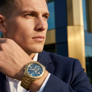 Professional man wearing Hugo Boss Ikon 1513340 with blue dial and gold metal link strap water resistant 100m