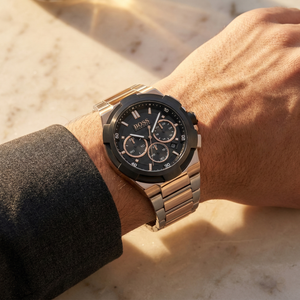 Close up of Hugo Boss Supernova 1513358 on wrist showing black dial and two-tone metal strap with 50m water resistance