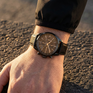 Close up of Hugo Boss Grand Prix 1513474 on wrist showing black dial and perforated leather strap with 50m water resistance