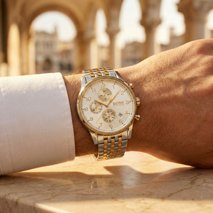 Close up of Hugo Boss Navigator Runner 1513499 on wrist showing white dial and silver gold metal strap with 50m water resistance