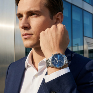 Professional man wearing Hugo Boss Companion 1513653 with blue dial and silver metal link strap water resistant 50m
