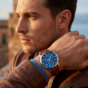 Professional man wearing Hugo Boss Spirit 1513689 with blue dial and silver case brown leather strap water resistant 30m