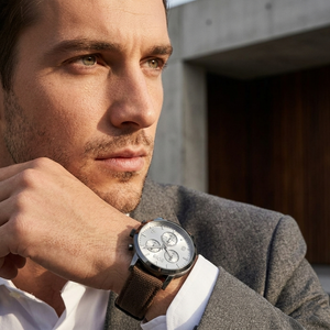Professional man wearing Hugo Boss Spirit 1513690 with silver dial and brown textile strap water resistant 30m