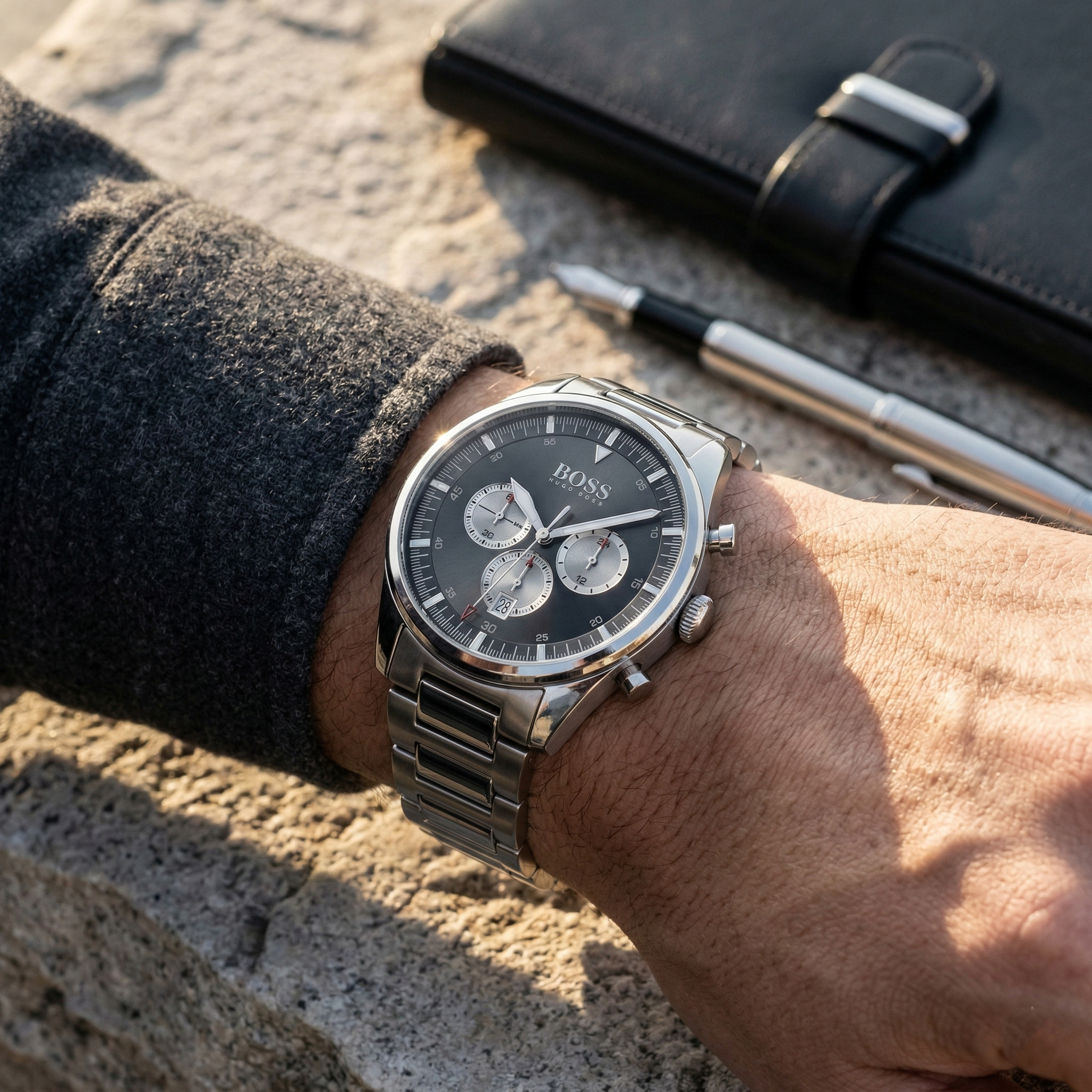 Close up of Hugo Boss Pioneer 1513712 on wrist showing black dial and silver metal link strap with 50m water resistance