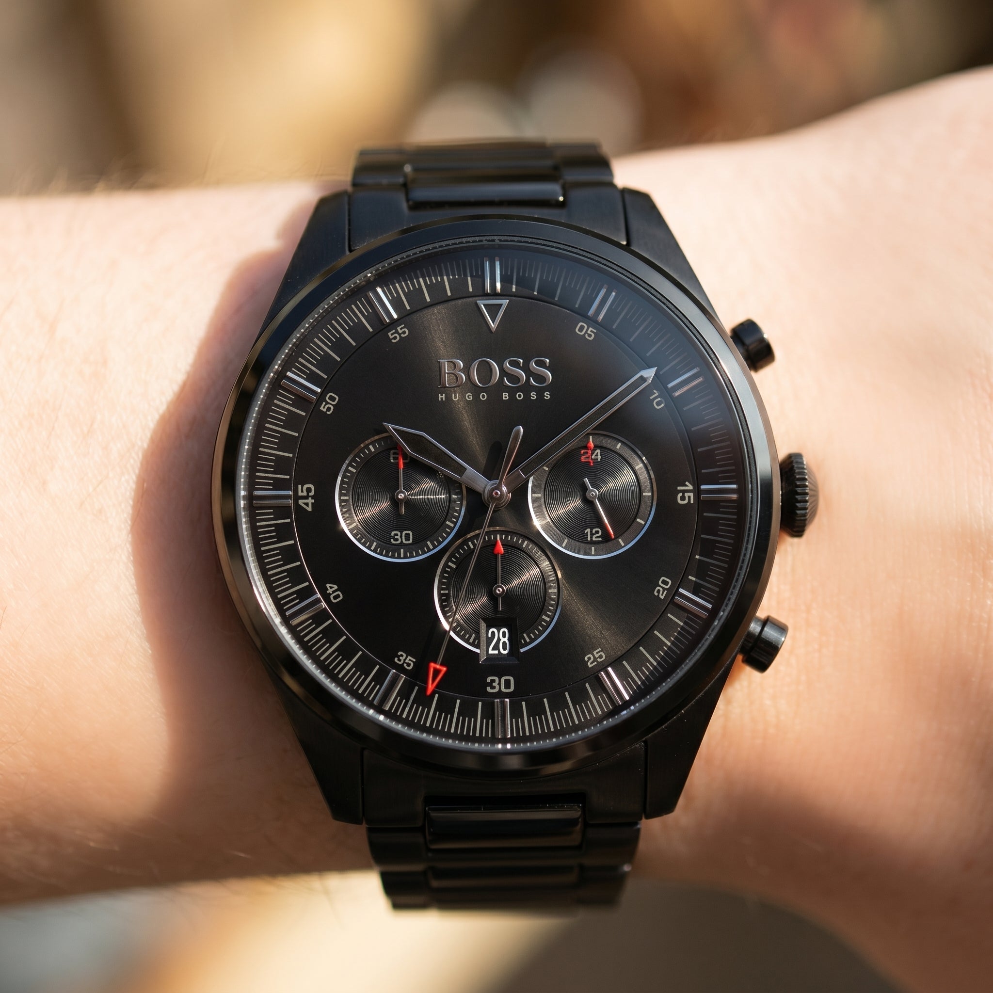 Raw close-up shot of Boss Pioneer 1513714 on wrist showing the black dial color and chronographic details from Luxury Hub Store.