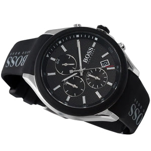 Black wristwatch with multiple time zones on a black background