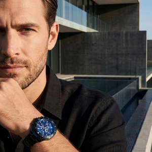 Professional explorer wearing Hugo Boss Ocean Edition 1513743 with blue dial and black metal strap water resistant 100m