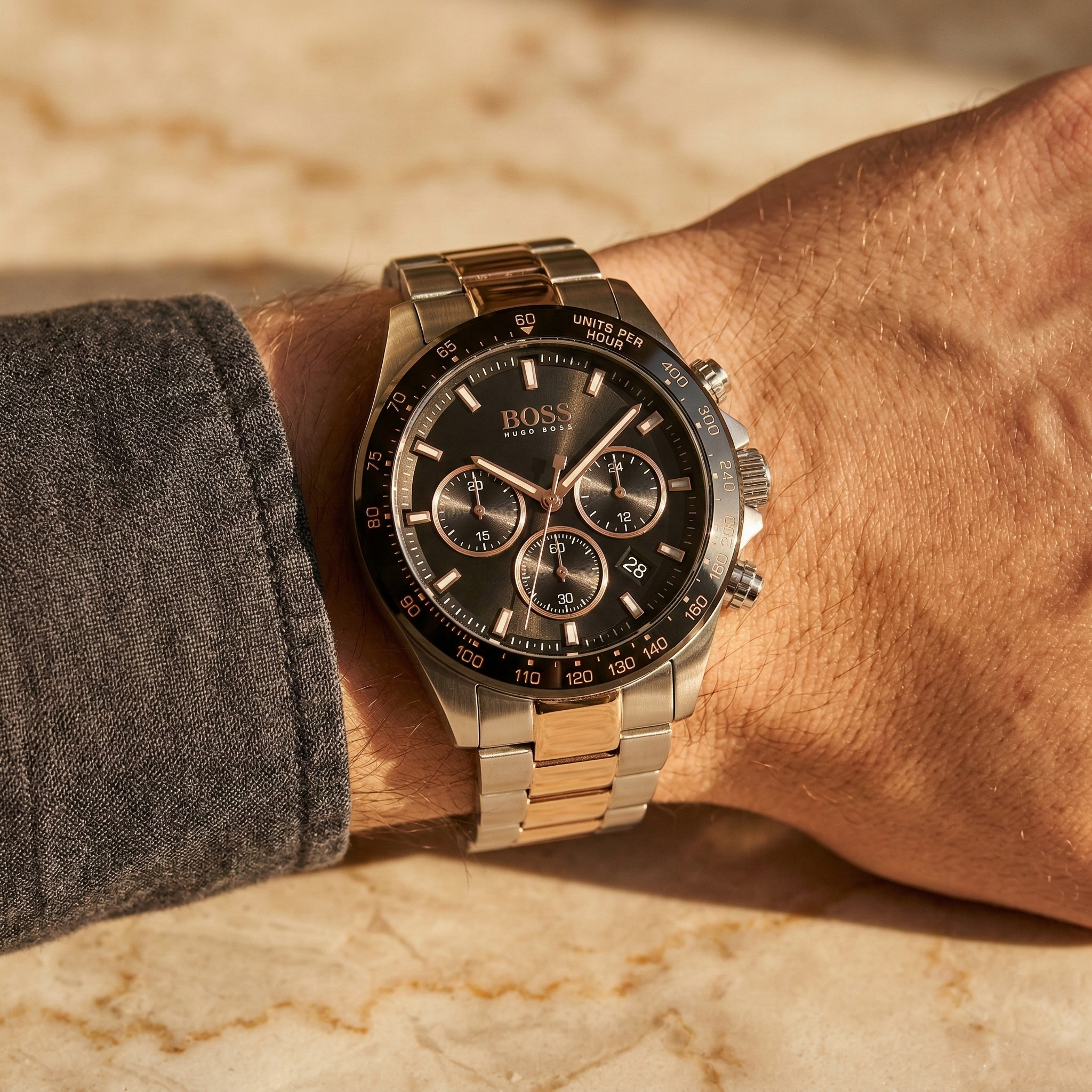 Close up of Hugo Boss Hero 1513757 on wrist showing black dial and two-tone metal strap with 50m water resistance