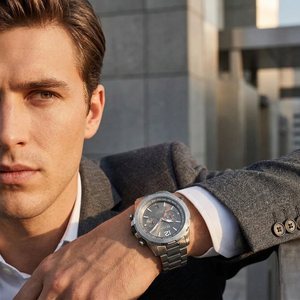 Professional man wearing Hugo Boss Nomad 1513774 with gray dial and silver metal link strap water resistant 50m