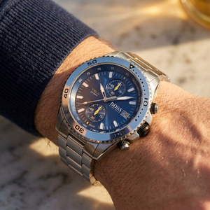 Close up of Hugo Boss Vela 1513775 on wrist showing blue dial and silver metal link strap with 50m water resistance