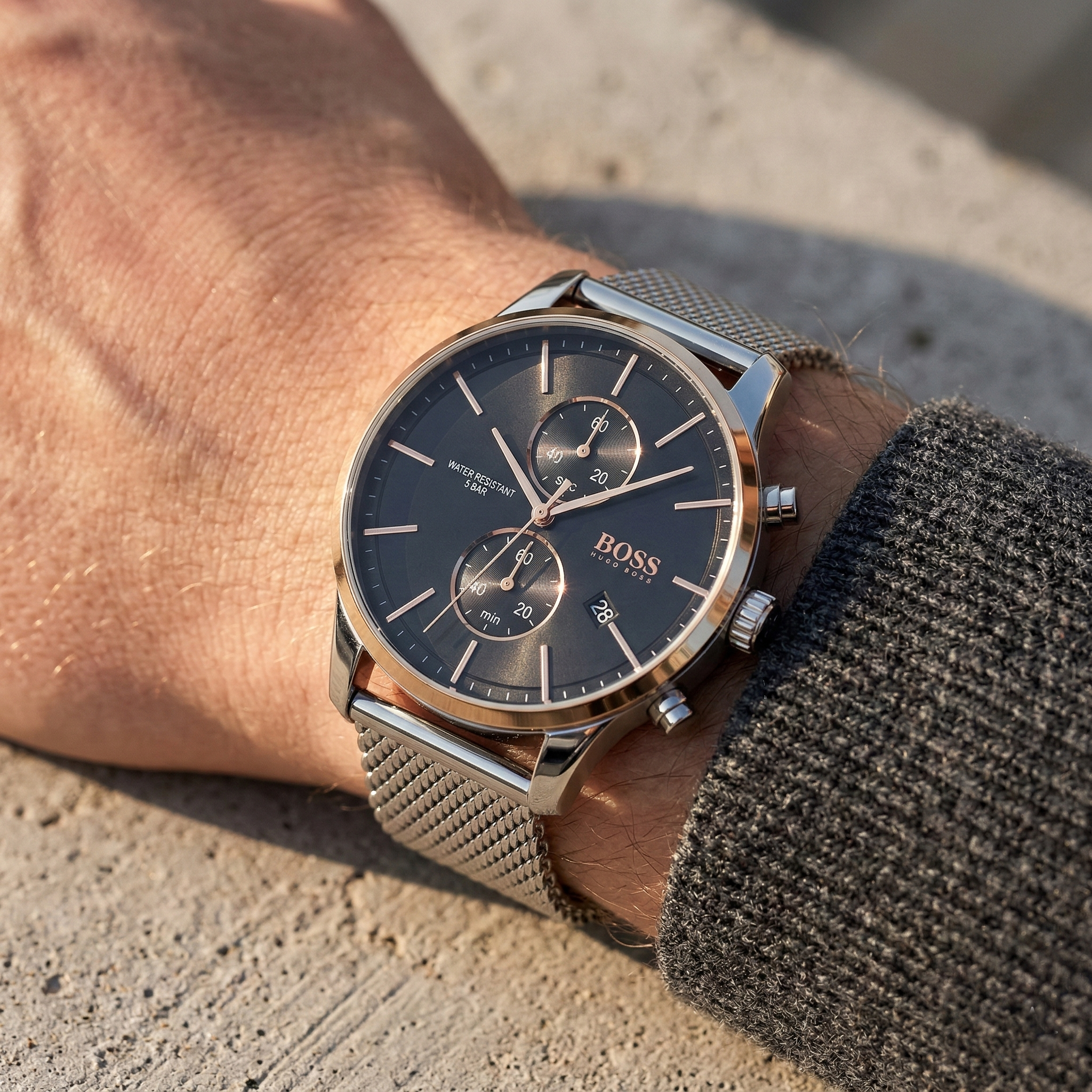 Close up of Hugo Boss Associate 1513805 on wrist showing black dial and silver metal mesh strap with 50m water resistance