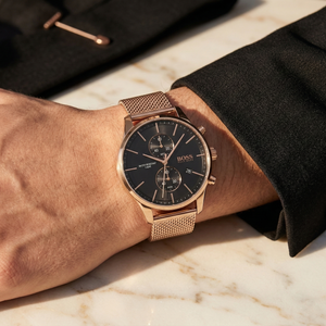 Close up of Hugo Boss Associate 1513806 on wrist showing black dial and rose gold metal mesh strap with 50m water resistance
