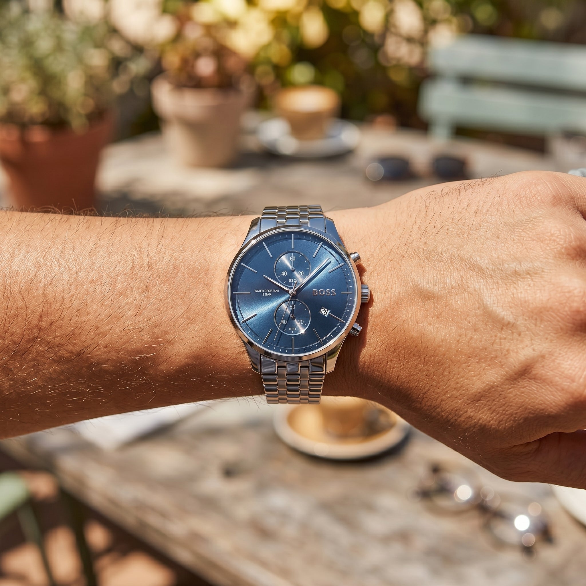 Close up shot of Boss Associate 1513839 on wrist showing the polished silver case and blue dial texture from Luxury Hub Store