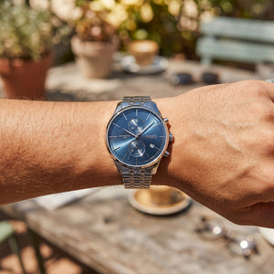 Close up shot of Boss Associate 1513839 on wrist showing the polished silver case and blue dial texture from Luxury Hub Store
