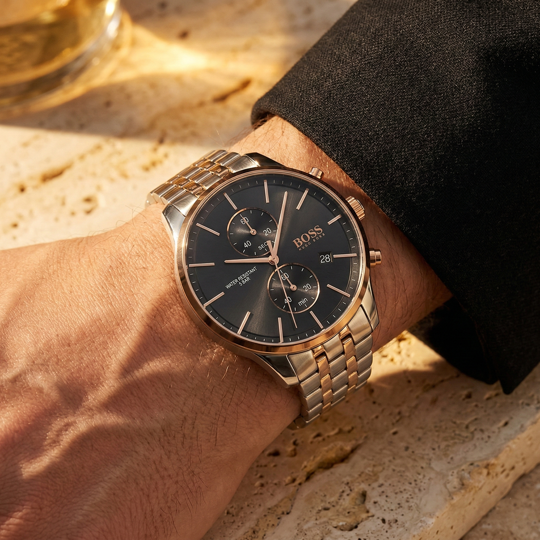 Close up of Hugo Boss Associate 1513840 on wrist showing black dial and two-tone metal strap with 50m water resistance