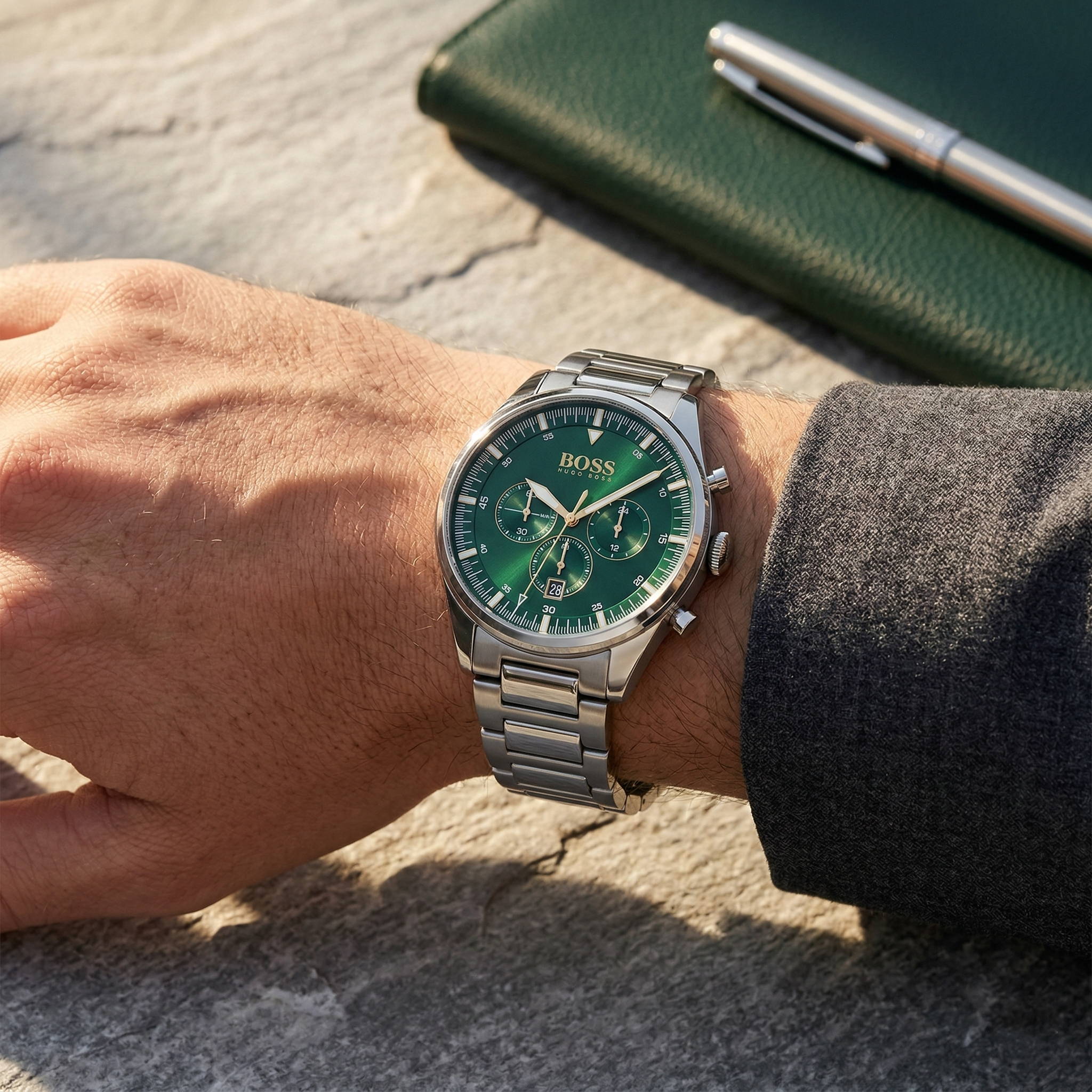 Close up of Hugo Boss Pioneer 1513868 on wrist showing green dial and silver metal link strap with 50m water resistance