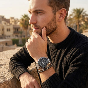 Elegant man wearing Hugo Boss Admiral 1513904 men's quartz battery watch with silver case and luxury racing black dial