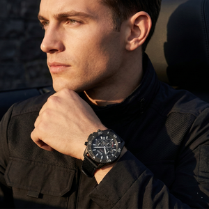 Professional man wearing Hugo Boss Admiral 1513918 solar powered watch made from recycled ocean plastic with black fiber strap