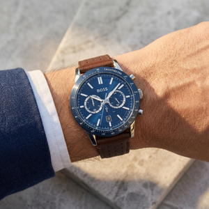 Close up of Hugo Boss Allure 1513921 on wrist showing blue dial and perforated brown leather strap with 50m water resistance