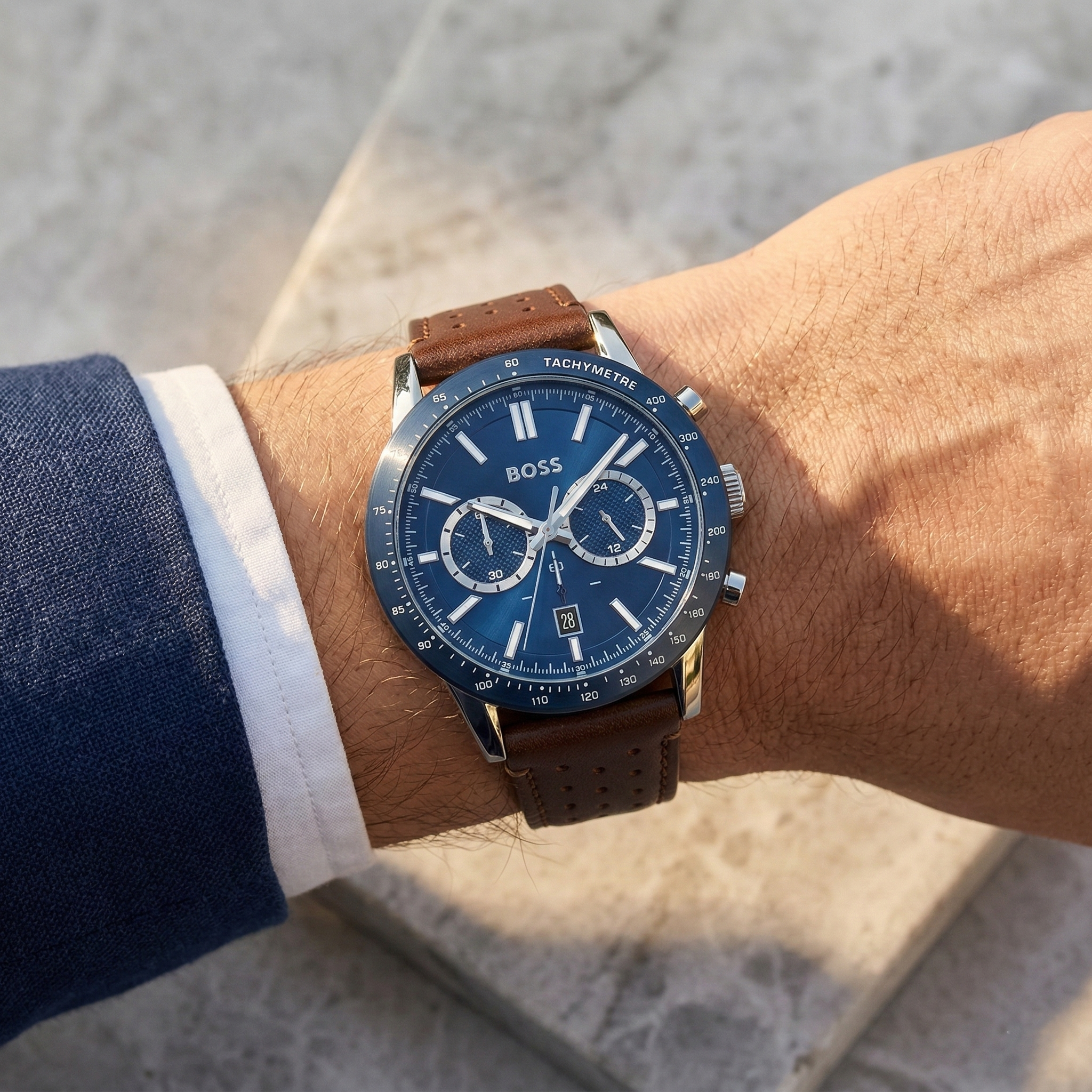 Close up of Hugo Boss Allure 1513921 on wrist showing blue dial and perforated brown leather strap with 50m water resistance