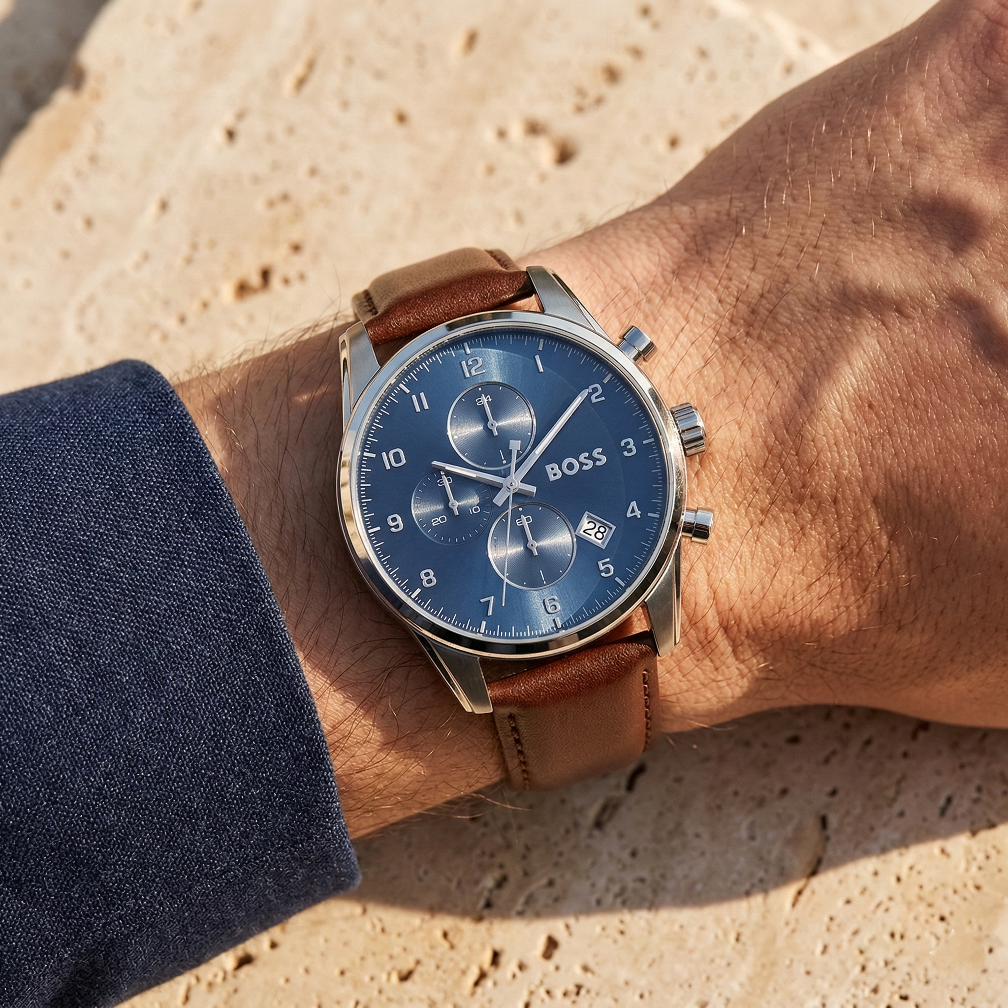 Close up of Hugo Boss Skymaster 1513940 on wrist showing blue dial and brown leather strap with 50m water resistance
