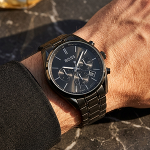 Close up of Hugo Boss Champion 1513960 on wrist showing black dial and black metal strap with 100m water resistance