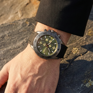 Close up of Hugo Boss Admiral 1513967 on wrist showing green dial and black rubber strap with 100m water resistance