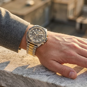 Close up of Hugo Boss Energy 1513974 on wrist showing gray sunray dial and two-tone metal strap with 50m water resistance