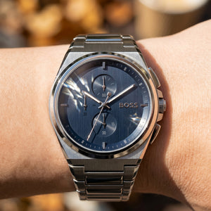 Close up shot of Boss Steer 1514048 on wrist showing the sleek integrated silver case and blue sunray dial from Luxury Hub Store