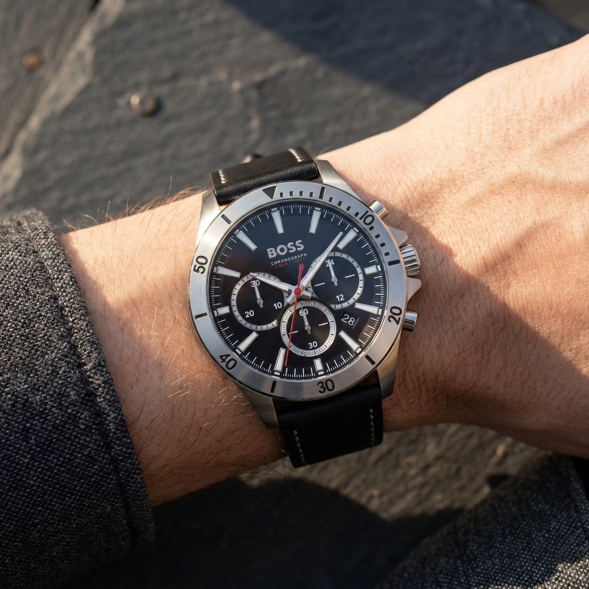 Close up of Hugo Boss Troper 1514055 on wrist showing black sunray dial and leather strap with 50m water resistance