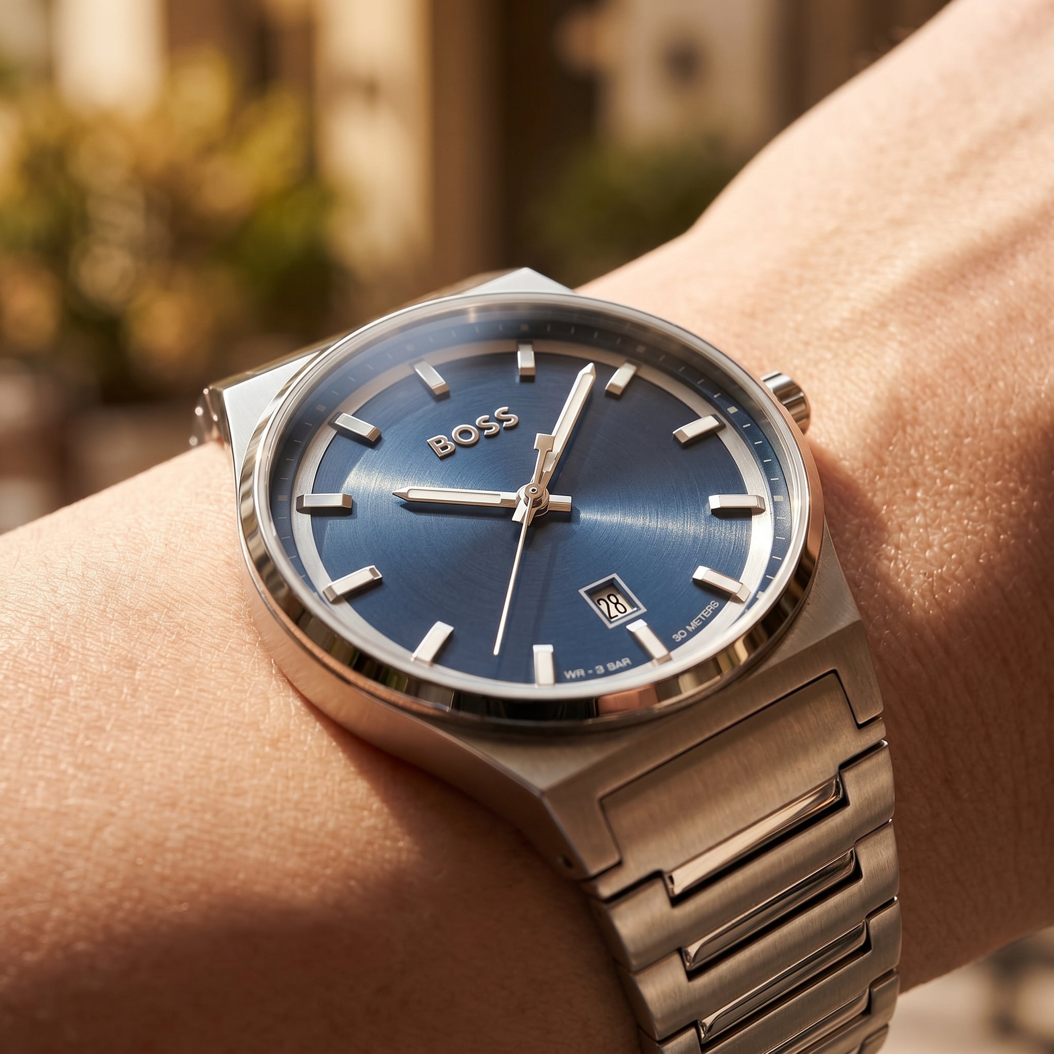 Close up shot of Boss Candor 1514076 on wrist showing the sleek silver case and minimalist blue dial from Luxury Hub Store