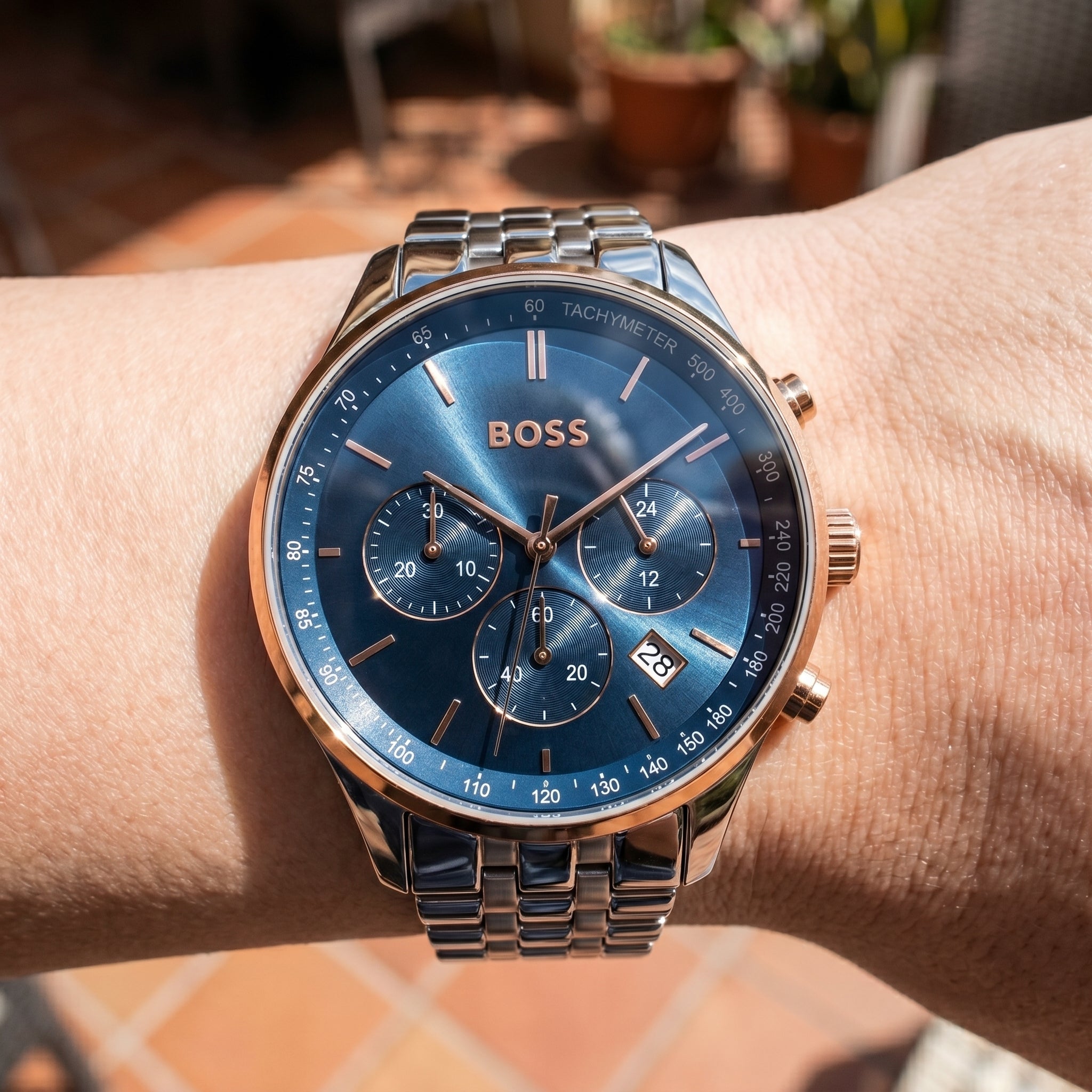 Close up shot of Boss Avery 1514158 on wrist showing the polished silver case and blue sunray dial texture from Luxury Hub Store
