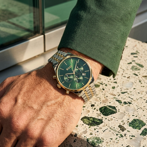 Close up of Hugo Boss Avery 1514159 on wrist showing green dial and silver gold case with 50m water resistance