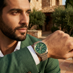 Professional man wearing Hugo Boss Sky Traveller 1514195 with green dial and silver metal strap water resistant 50m