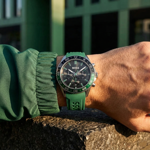 Close up of Hugo Boss Runner 1514246 on wrist showing black dial and green rubber strap with 50m water resistance