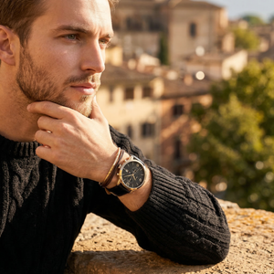 Elegant man wearing Tommy Hilfiger Liam 1710358 men's quartz battery watch with gold-tone case and luxury black dial