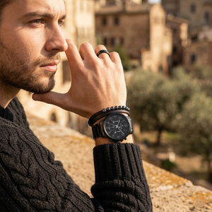 Elegant man wearing Tommy Hilfiger Daniel 1710383 men's quartz battery watch with black-tone case and luxury logo dial