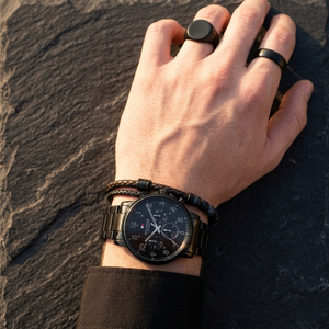 Close up of Tommy Hilfiger Daniel 1710383 men's quartz battery watch on wrist showing black multi-function dial and black metal bracelet