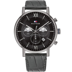 Tommy Hilfiger Evan Men's Chronograph Watch 1710395 main view on human wrist angled profile view round silver stainless steel case dynamic fixed smooth bezel black sunray dial luminous hands applied gold indices three sub-dials integrated black leather calfskin strap with white contrast stitching