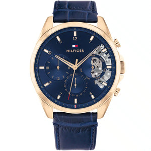 Tommy Hilfiger Damon 1710451 men's watch featuring a gold-tone stainless steel case, navy blue multi-function dial, and blue leather strap