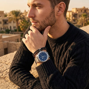 Elegant man wearing Tommy Hilfiger Jax 1710656 men's quartz battery watch with silver case and luxury racing blue dial