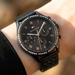 Close up shot of Tommy Hilfiger 1782144 on wrist showing black dial and Roman numeral sub-dials