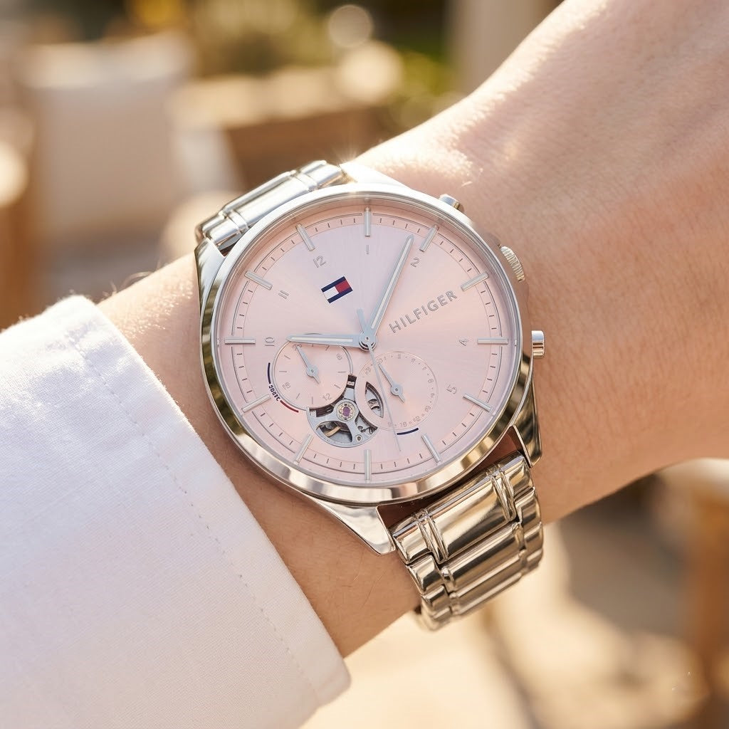 Close up shot of Tommy Hilfiger 1782414 on wrist showing pink dial and heartbeat movement aperture
