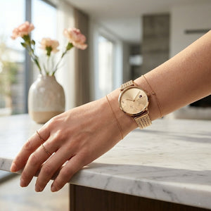 Close up of Tommy Hilfiger Carnation 1782603 women's quartz battery watch on wrist showing Gold Rose floral dial and luxury mesh bracelet