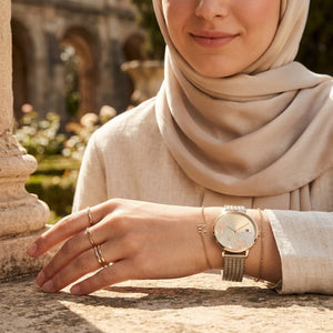 Elegant woman wearing Tommy Hilfiger Carnation 1782603 women's quartz battery watch with Rose Gold case and luxury jewelry mesh strap