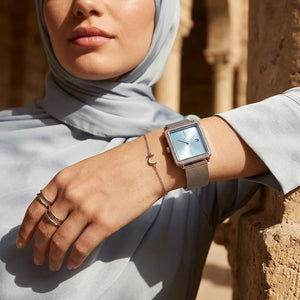 Elegant woman wearing Tommy Hilfiger Tea 1782789 women's quartz battery watch with silver case and luxury square mesh strap