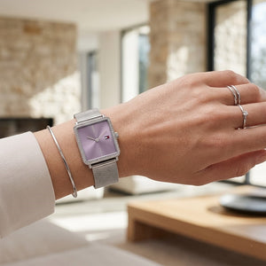 Close up of Tommy Hilfiger Tea 1782790 women's quartz battery watch on wrist showing square lavender dial and luxury crystal bezel