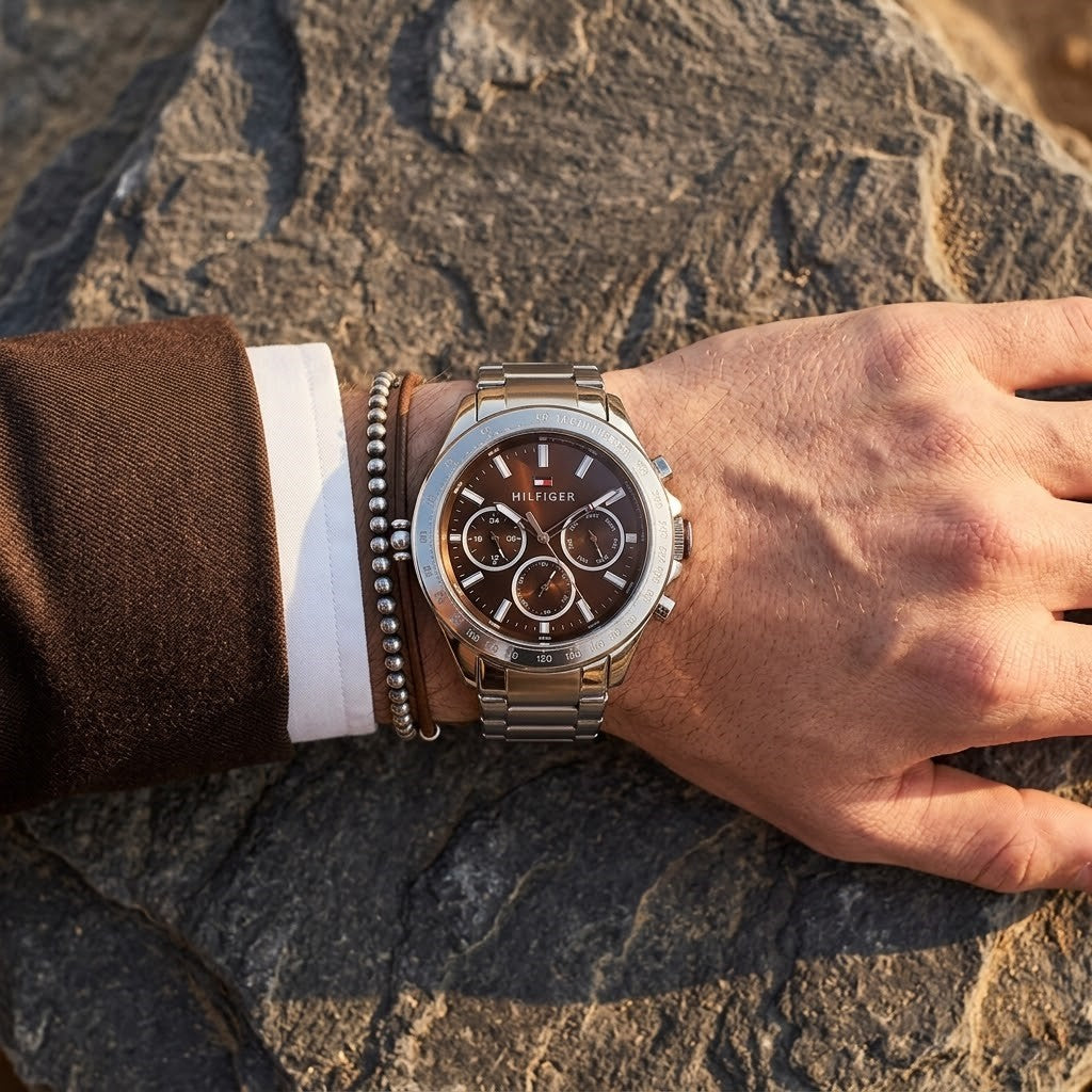 Close up of Tommy Hilfiger Hudson 1791229 watch (Silver Round Case/Brown Dial variant) on wrist angled profile view showing distinct dynamic brown sunray dial dynamic multi-function display sub-dials and luminous central analogue Central central minute track dynamic visual casual luxury